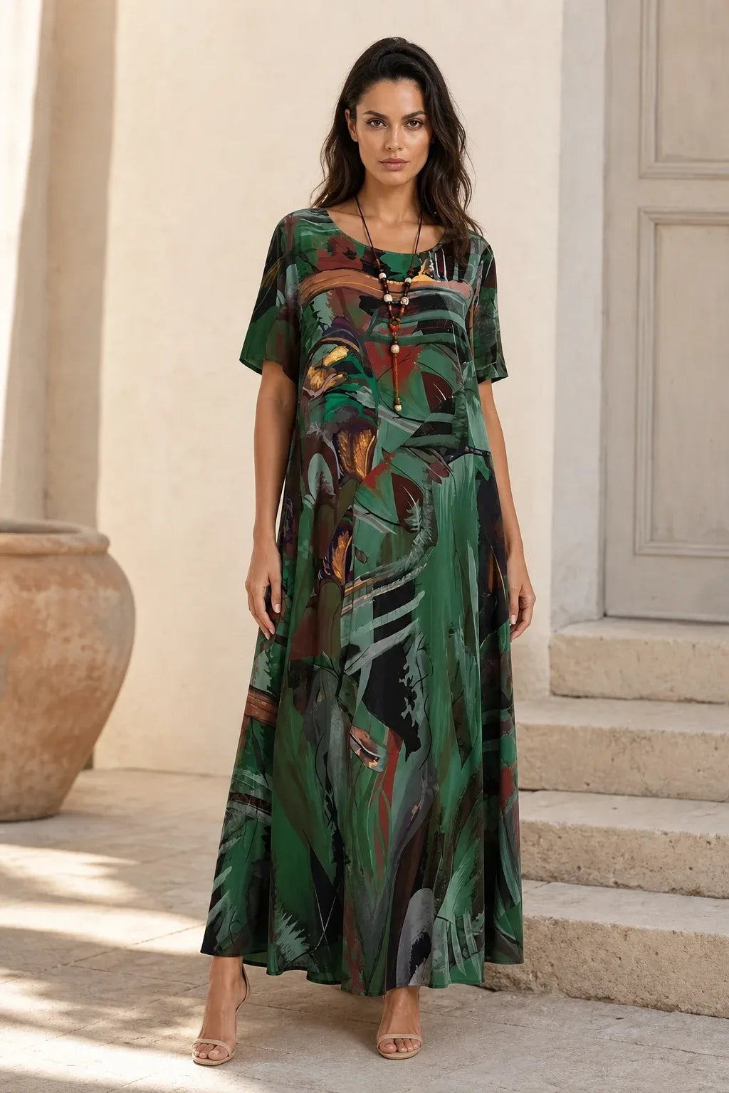Green abstract-print midi dress on model standing in contrapposto pose