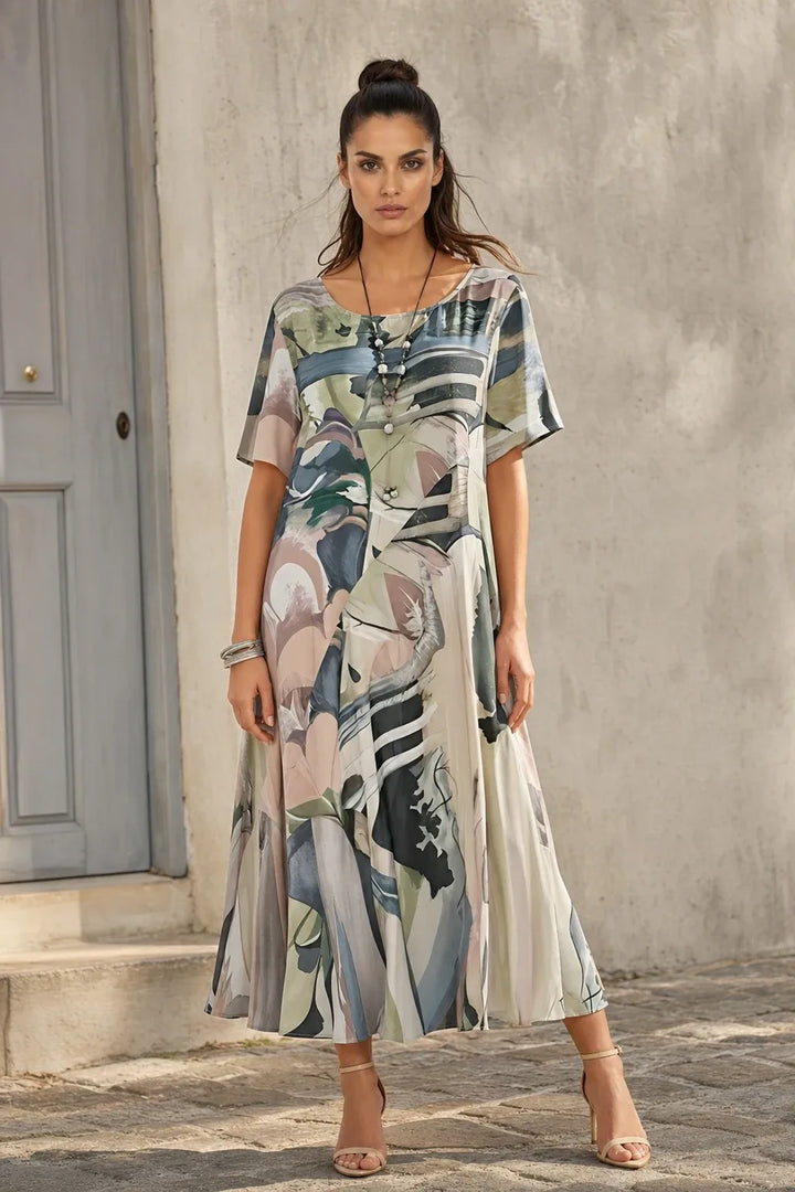 Grey abstract-print midi dress on model standing in contrapposto pose