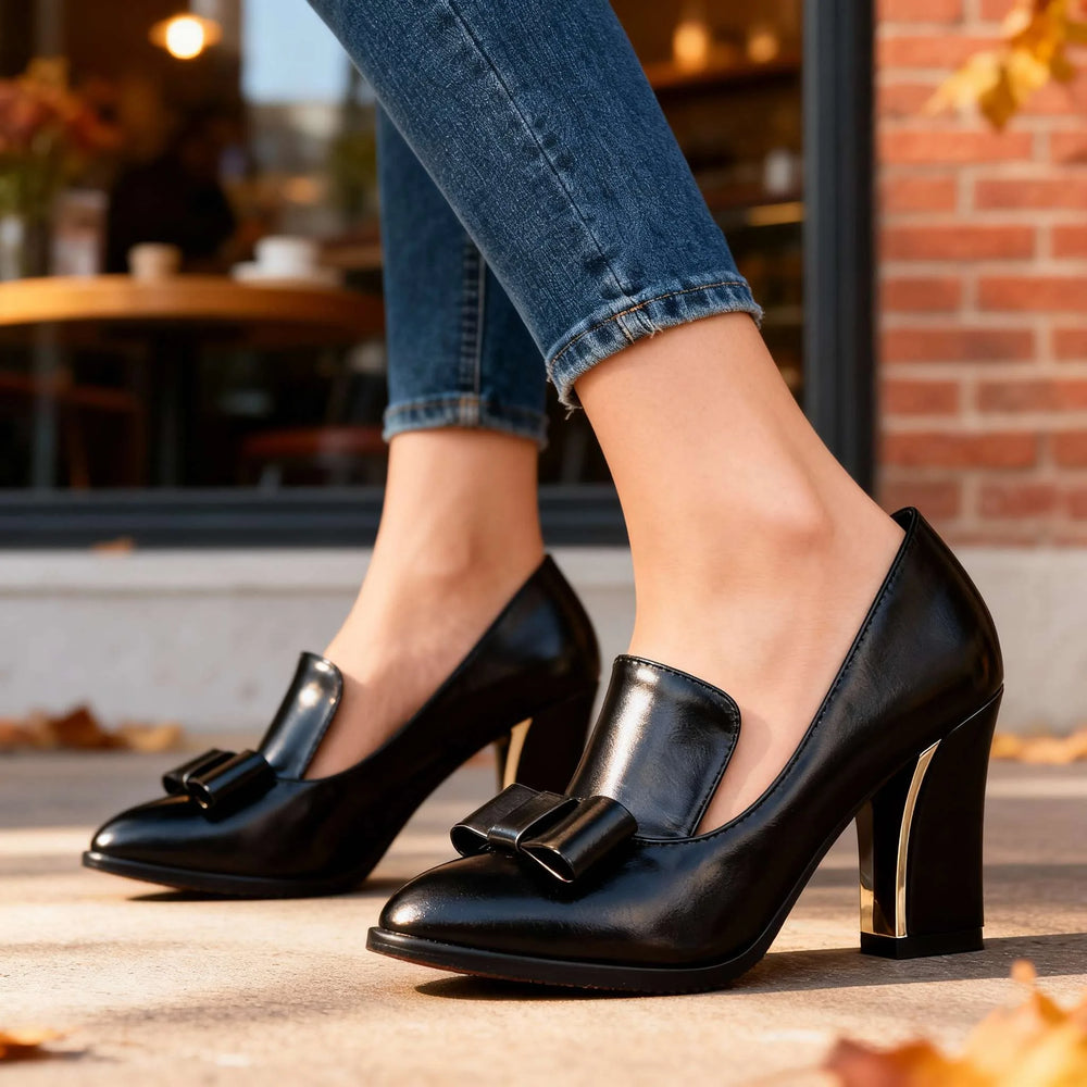 Close-up detail of bow accent on black loafer pump
