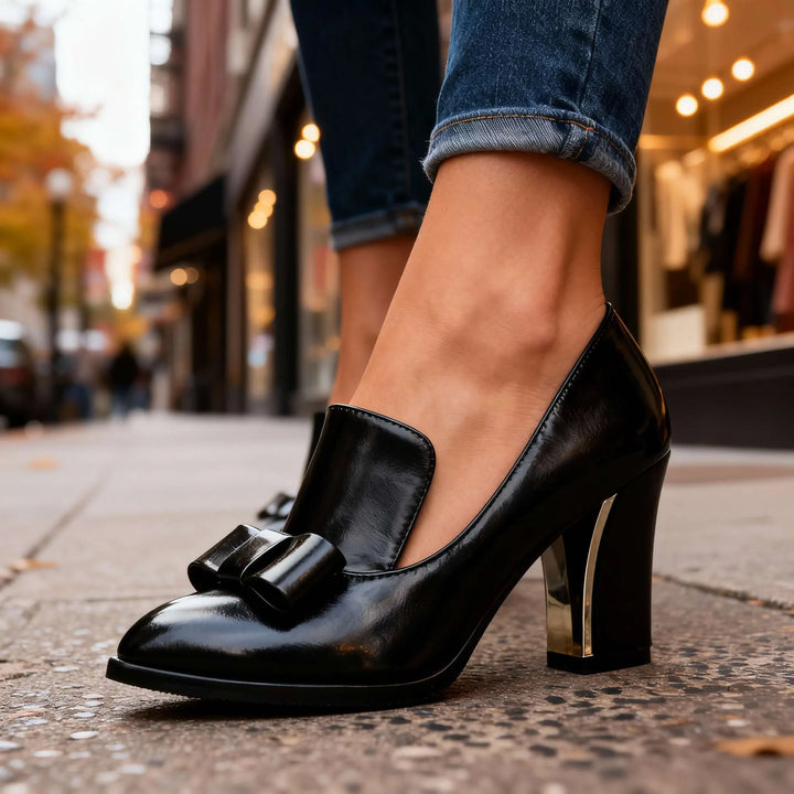 Black loafer pump with bow detail, side profile view