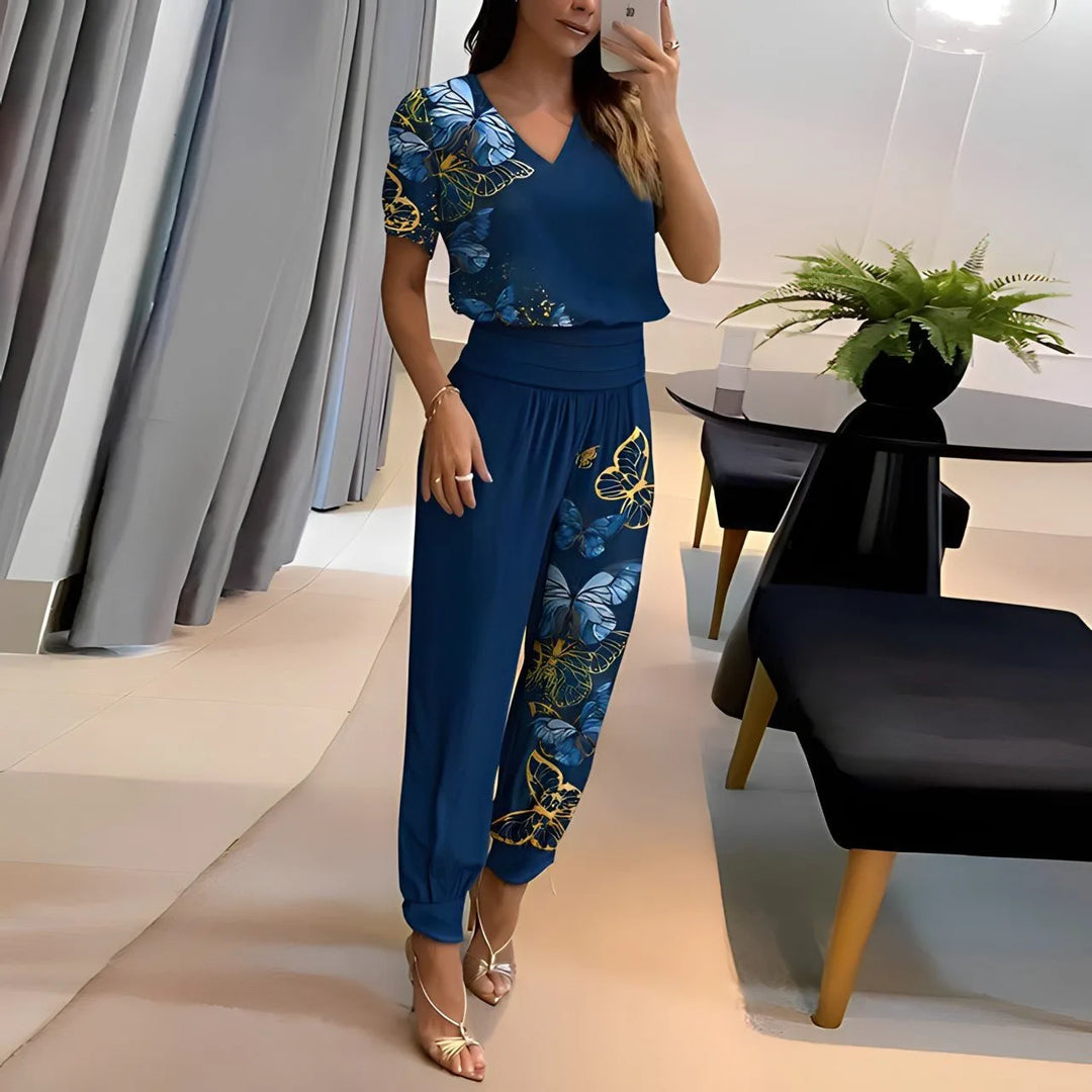 Woman wearing blue printed jogger set, posed at a three-quarter turn