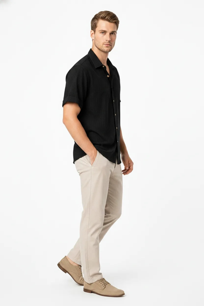 Black ribbed corduroy shirt on model in three-quarter turn