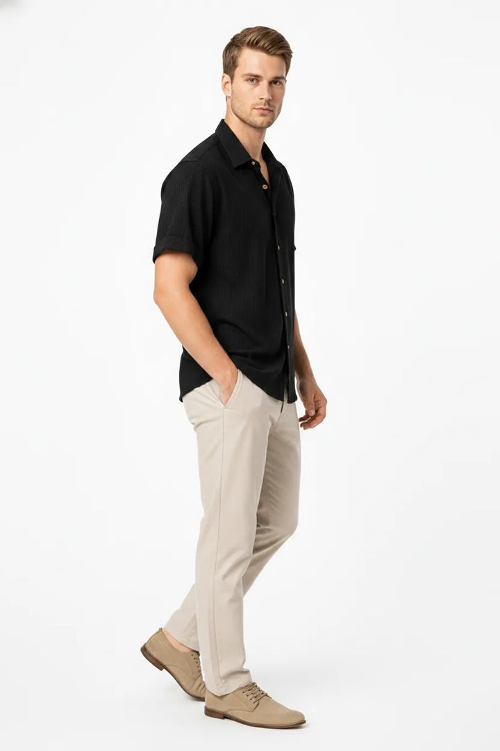 Black ribbed corduroy shirt on model in three-quarter turn