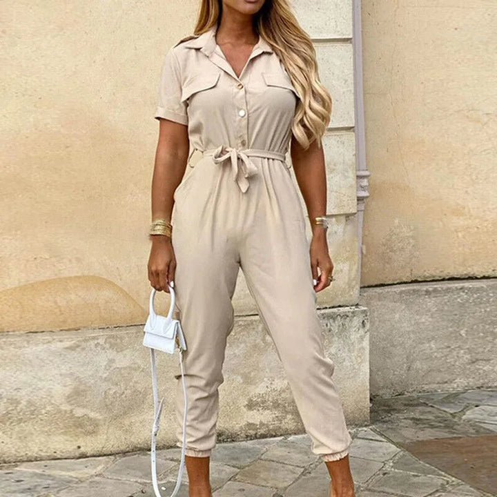 Model wearing a beige striped belted jumpsuit