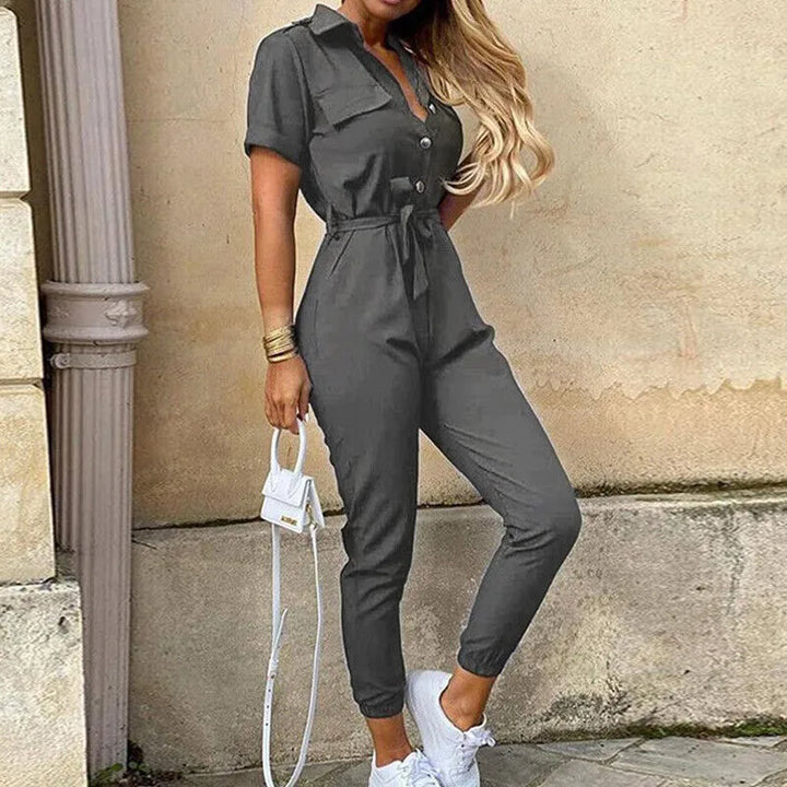 Model wearing a gray striped belted jumpsuit