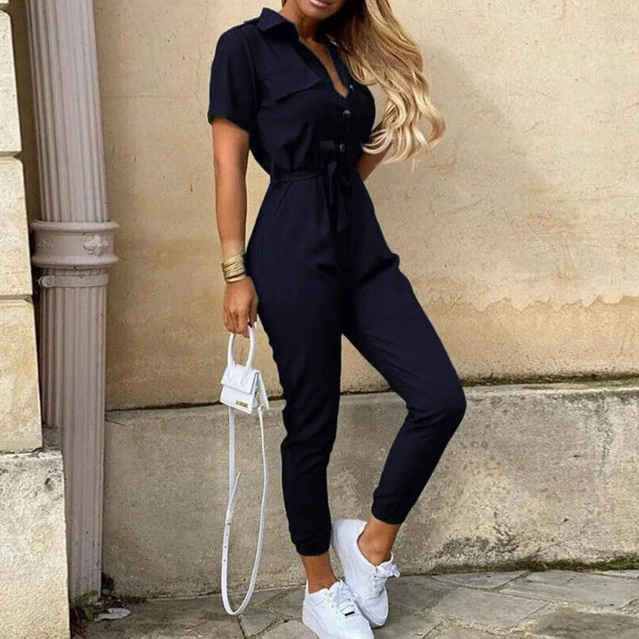 Model wearing a navy blue striped belted jumpsuit