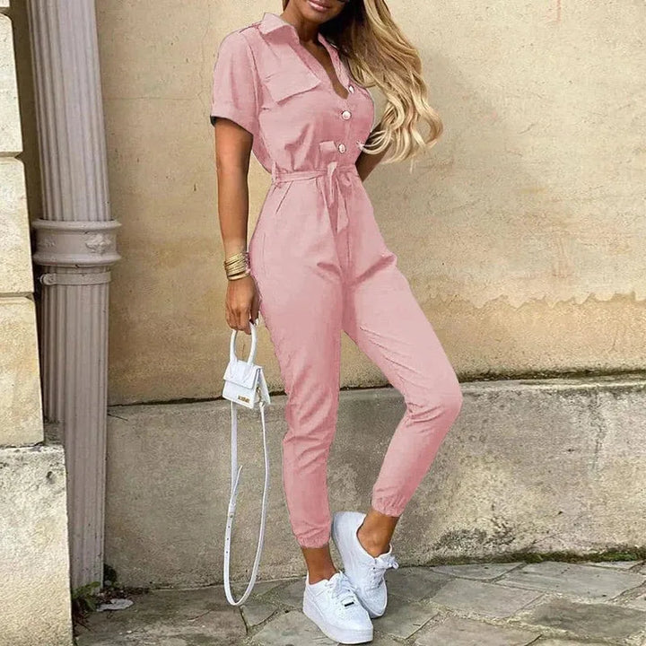 Model wearing a pink striped belted jumpsuit