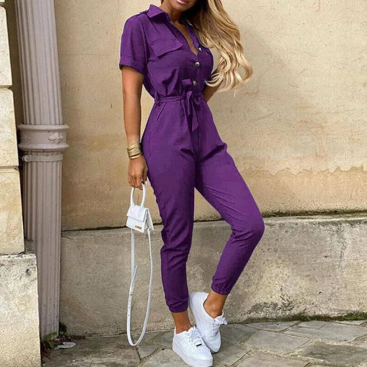 Model wearing a purple striped belted jumpsuit