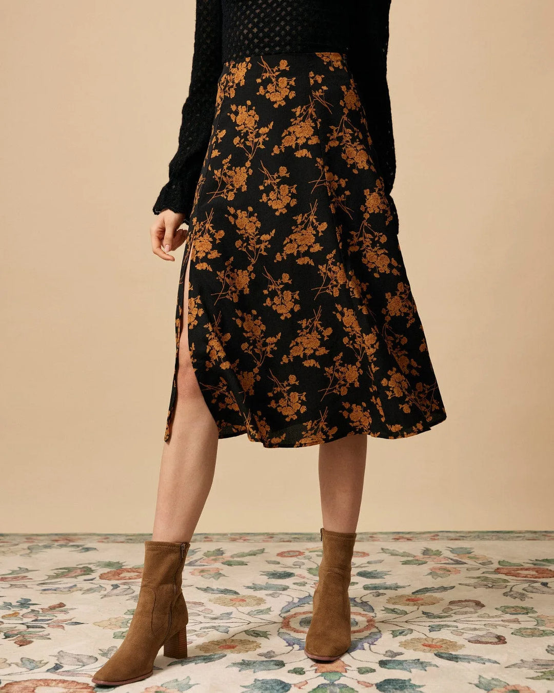 Black floral midi dress with front slit, model standing facing forward