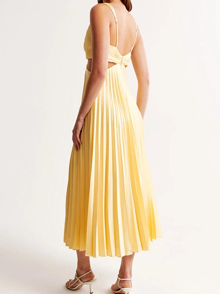 Close-up of the pleated fabric and cutout detail on a yellow midi dress