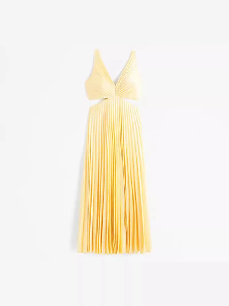 Woman in a yellow pleated cutout midi dress, alternate full-length pose