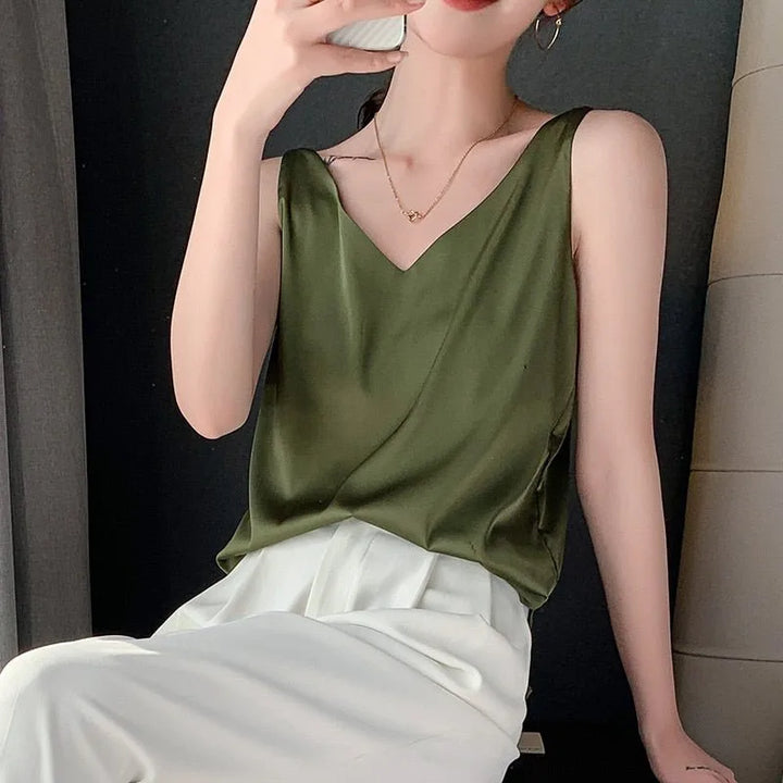 Dark green satin v-neck cami on model in side profile