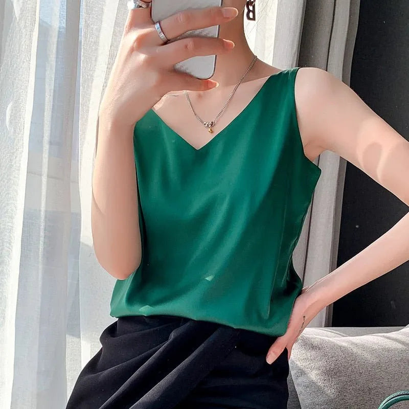 Green satin v-neck cami on model at three-quarter turn