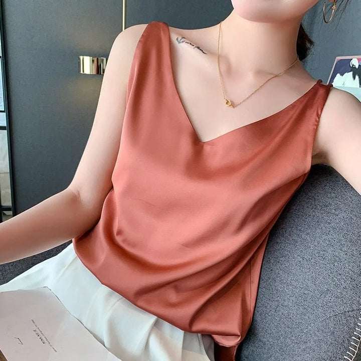 Close-up detail of orange satin v-neck cami fabric and neckline