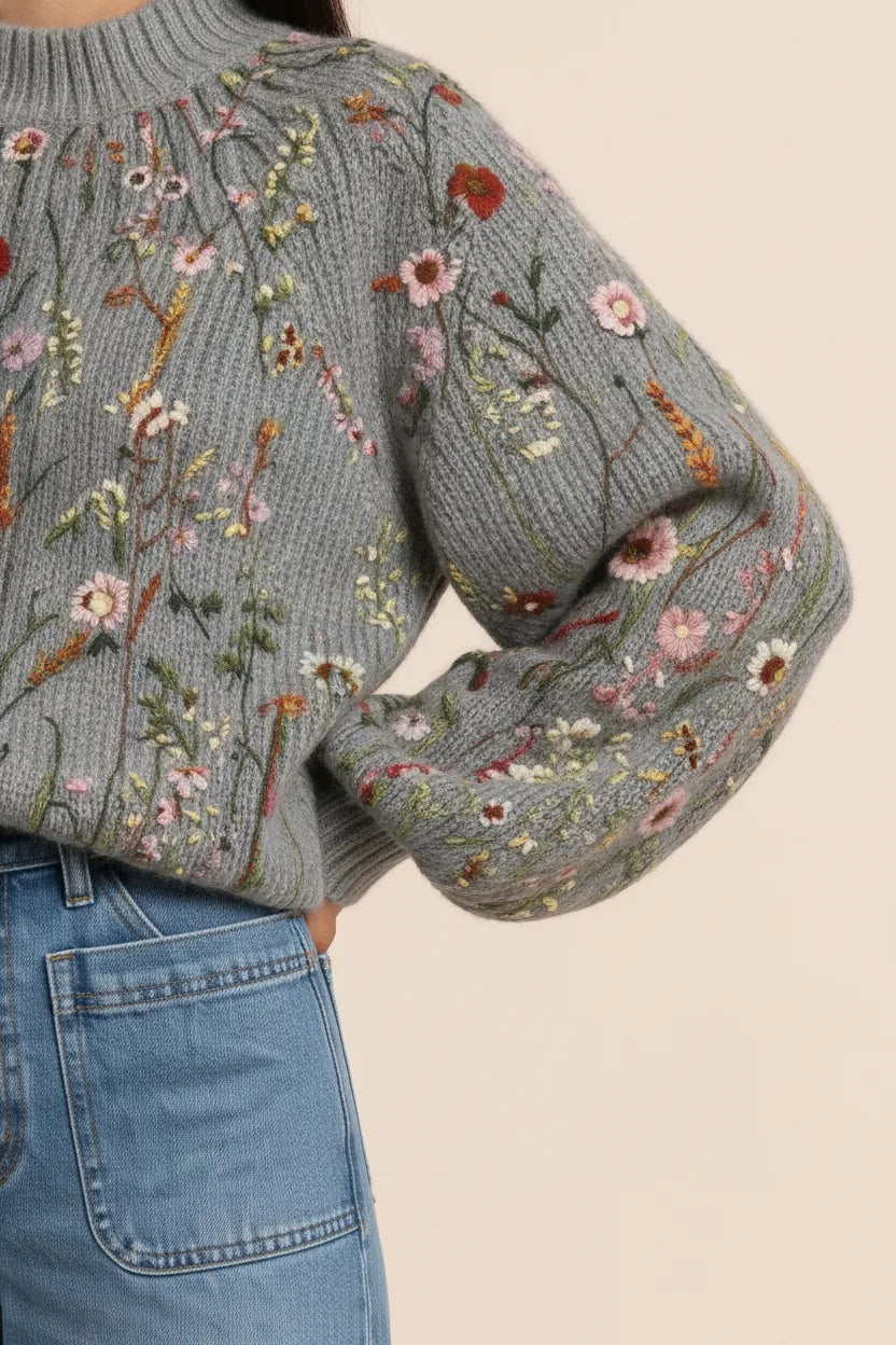 Close-up detail of multicolor embroidered floral pattern on a knit top