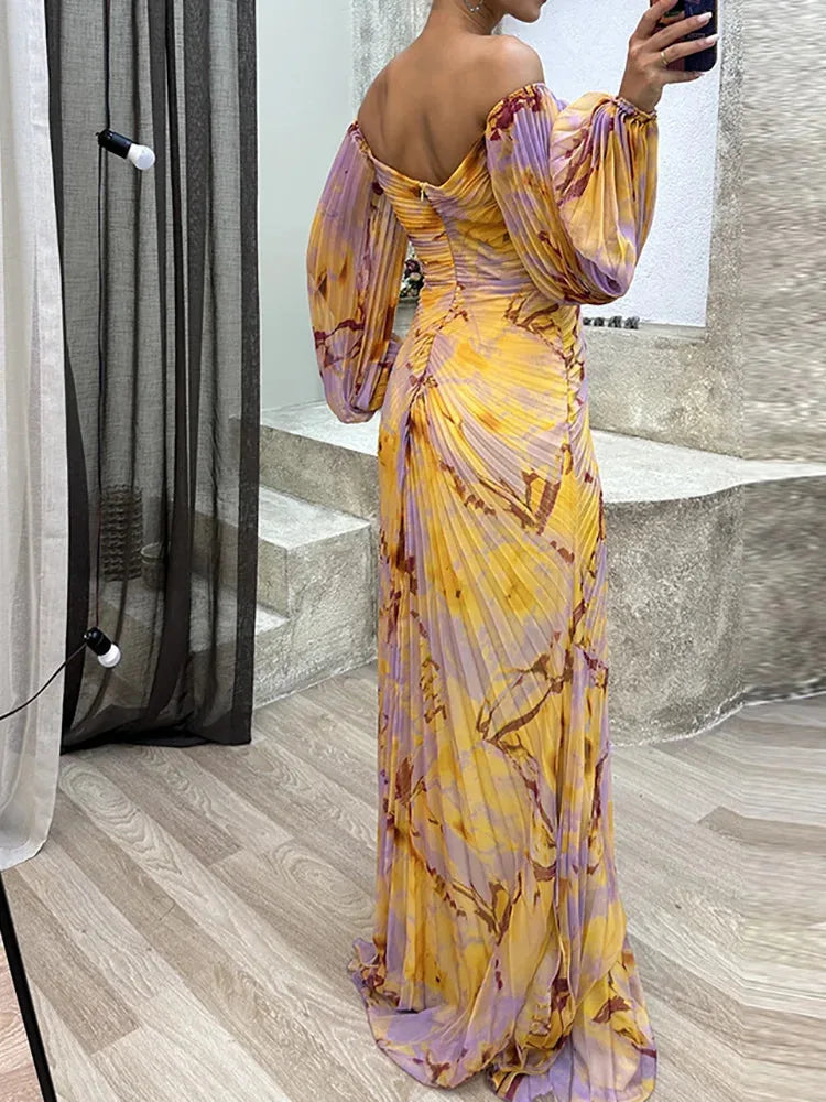 Woman in a pleated off-shoulder multicolor gown, side view