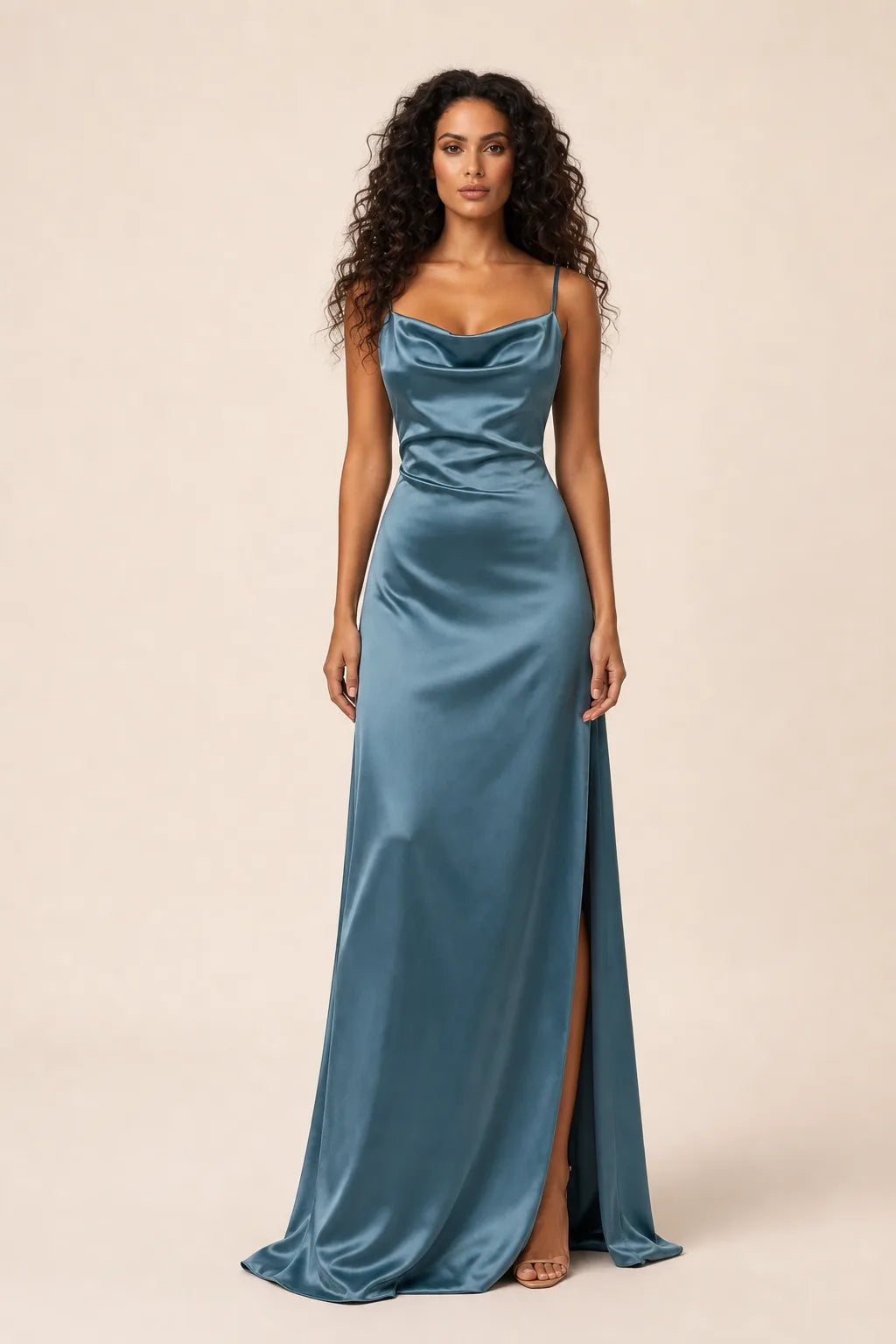 Blue cowl neck backless gown on model in contrapposto stance