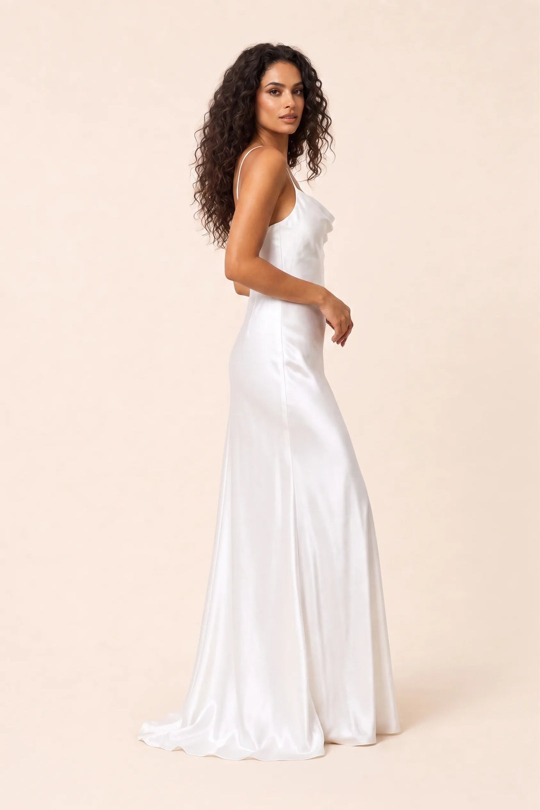 White cowl neck backless gown on model in three-quarter turn