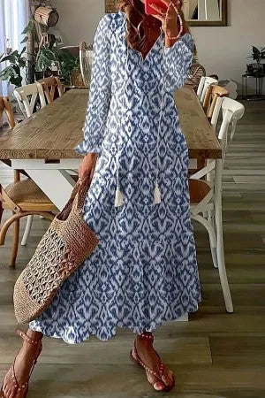 Blue boho maxi dress with tassel detail, model shown from the side