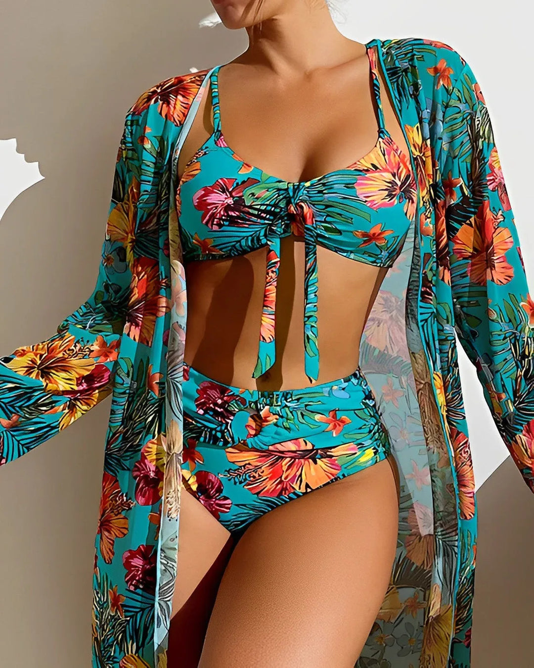 Woman wearing a blue tropical print bikini set, standing facing forward