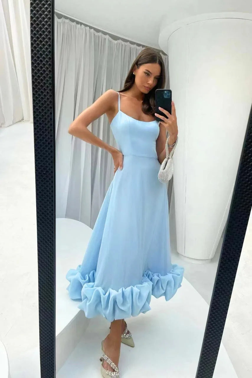 Model in a black ruffle hem midi dress showcasing fit and ruffle hem detail