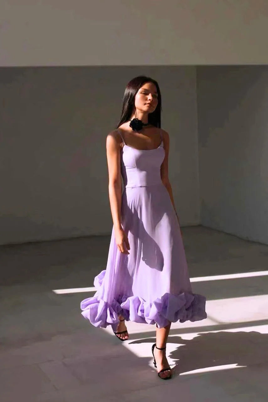 Model styled in a black ruffle hem midi dress showing full-length view