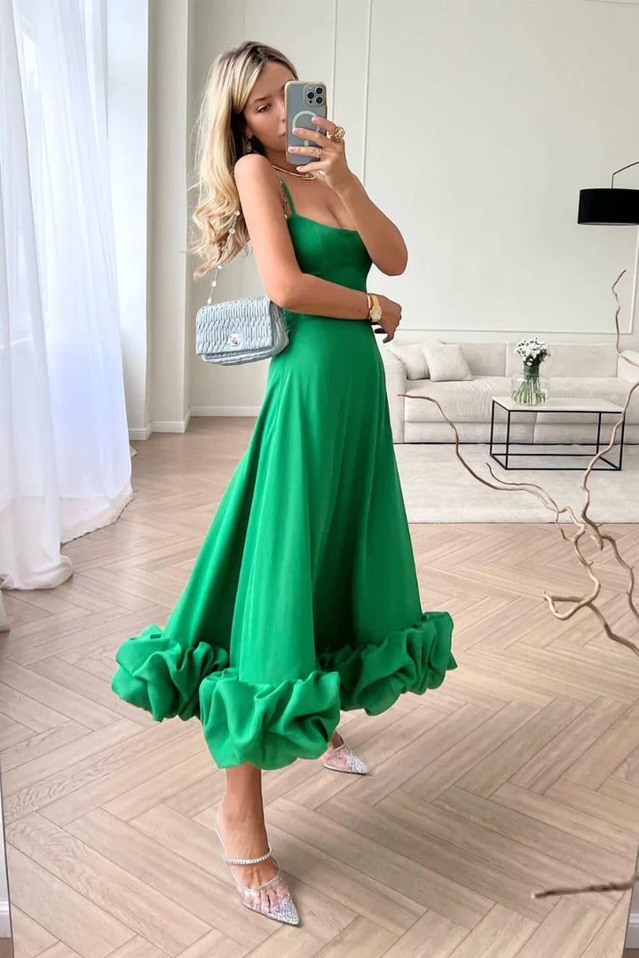 Model wearing a green ruffle hem midi dress with tiered ruffle hem