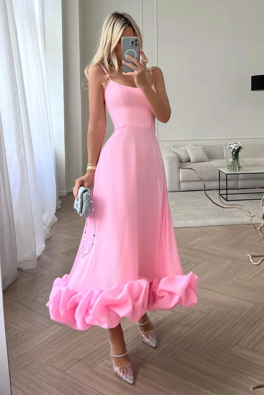 Close-up detail of pink ruffle hem midi dress showing tiered skirt layers