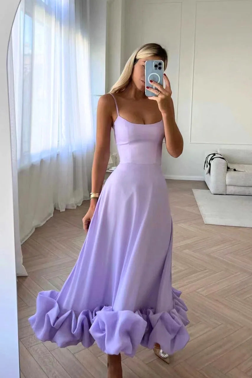 Model wearing a purple ruffle hem midi dress with layered ruffle skirt detail