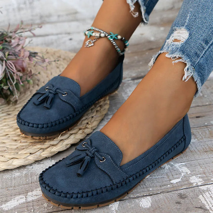 Blue suede loafer with tassel tie detail, front view