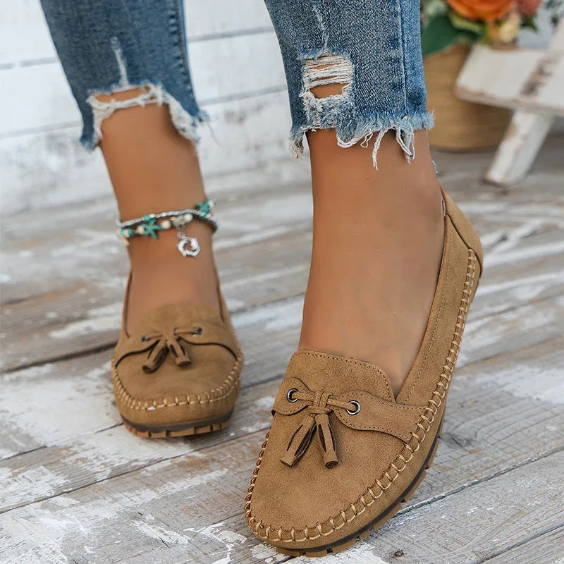 Brown suede loafer with tassel tie detail, front view