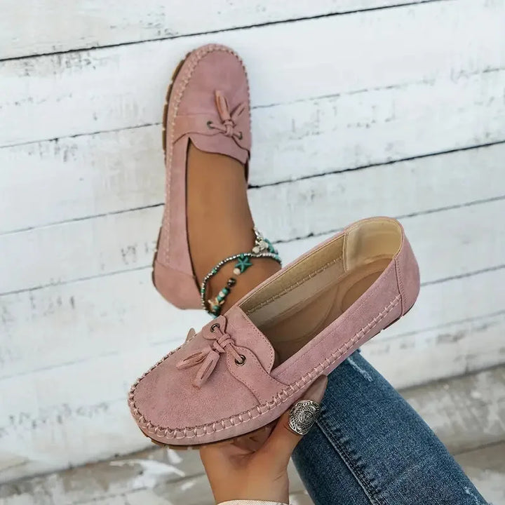 Pink suede loafer with tassel tie detail, front view