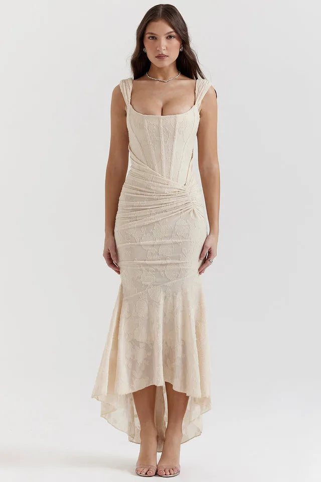 Model in a beige lace mermaid gown with a form-fitting silhouette and flared hem
