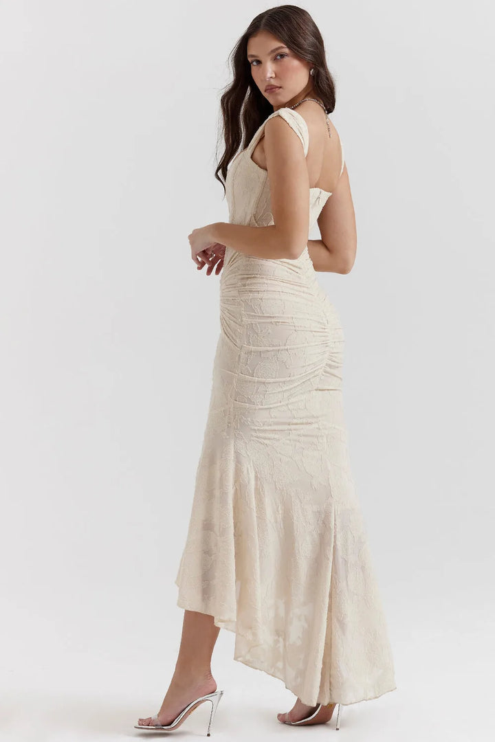 Full-length view of a model in a pink lace mermaid gown with delicate lace overlay