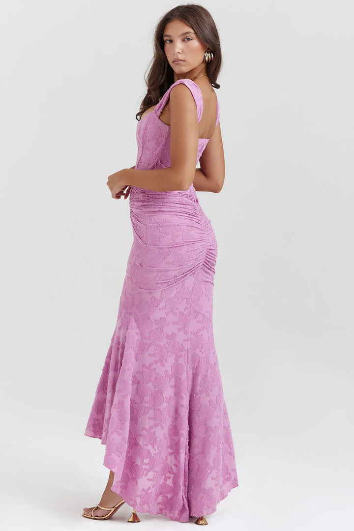 Model posing in a pink lace mermaid gown with elegant floral lace detailing