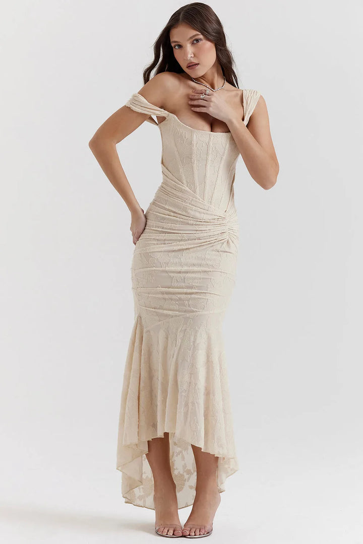 Model wearing a pink lace mermaid gown with a sweeping train and fitted bodice