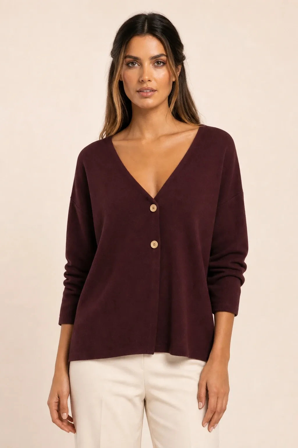 Burgundy button-front knit cardigan on model in contrapposto stance
