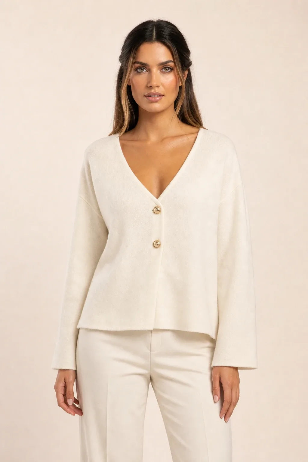 Yellow button-front knit cardigan on model in contrapposto stance
