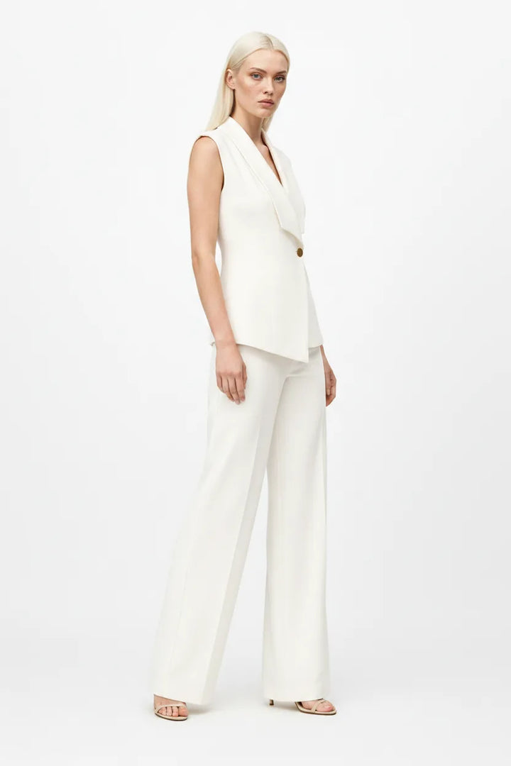 White sleeveless blazer suit on model in three-quarter turn
