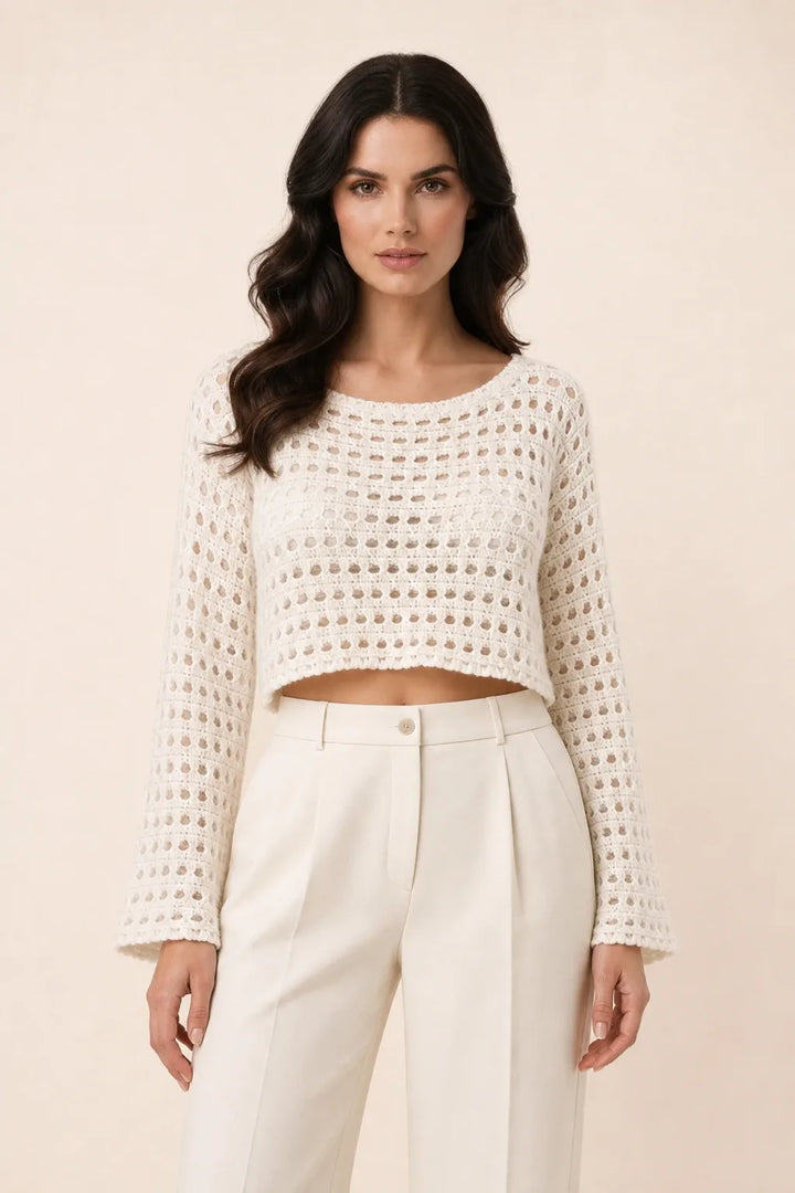 Apricot open knit crop top on model in contrapposto stance