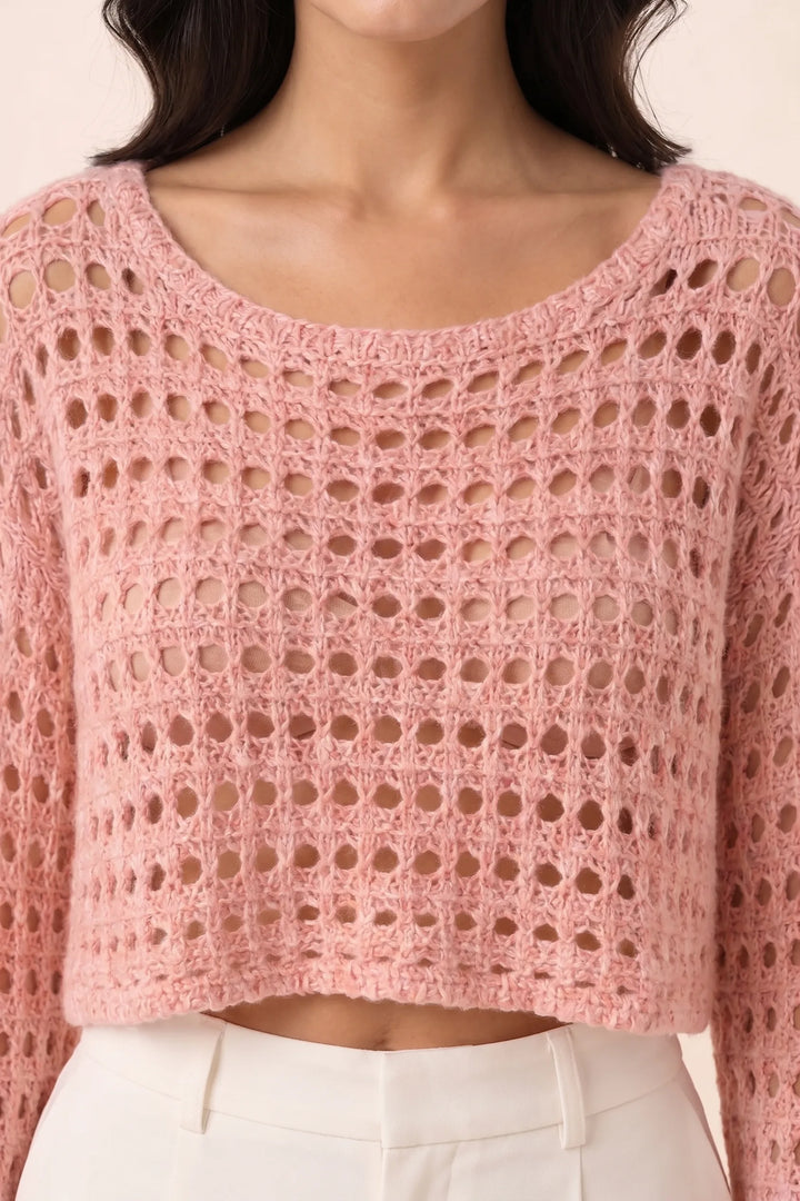 Close-up detail of pink open knit crop top texture and construction