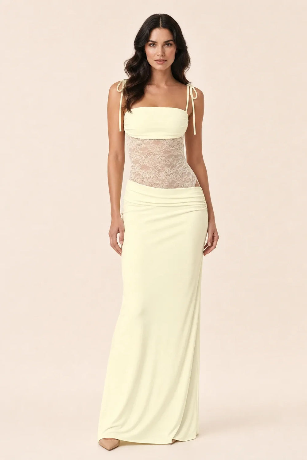 Light yellow lace corset maxi dress on model in contrapposto stance