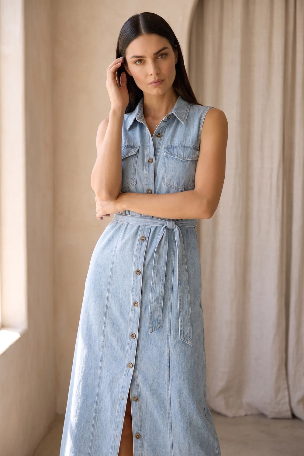 Woman wearing a belted blue denim maxi dress in a lifestyle setting