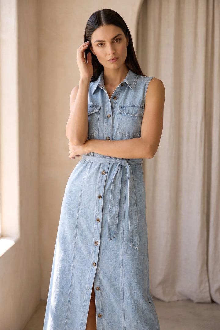 Woman wearing a belted blue denim maxi dress in a lifestyle setting