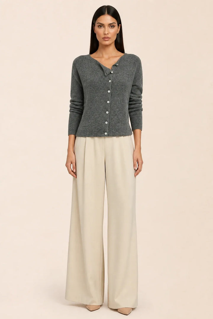 Gray asymmetric button cardigan on a model in a contrapposto stance