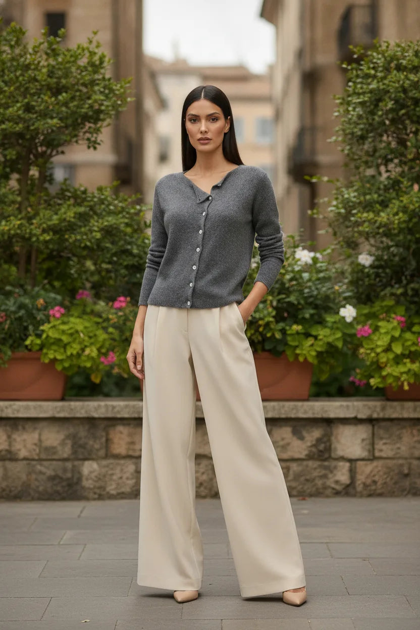 Gray asymmetric button cardigan displayed outside a storefront