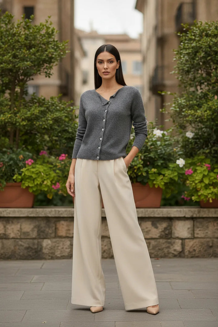 Gray asymmetric button cardigan displayed outside a storefront