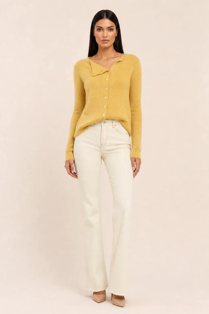 Yellow asymmetric button cardigan on a model in a contrapposto stance