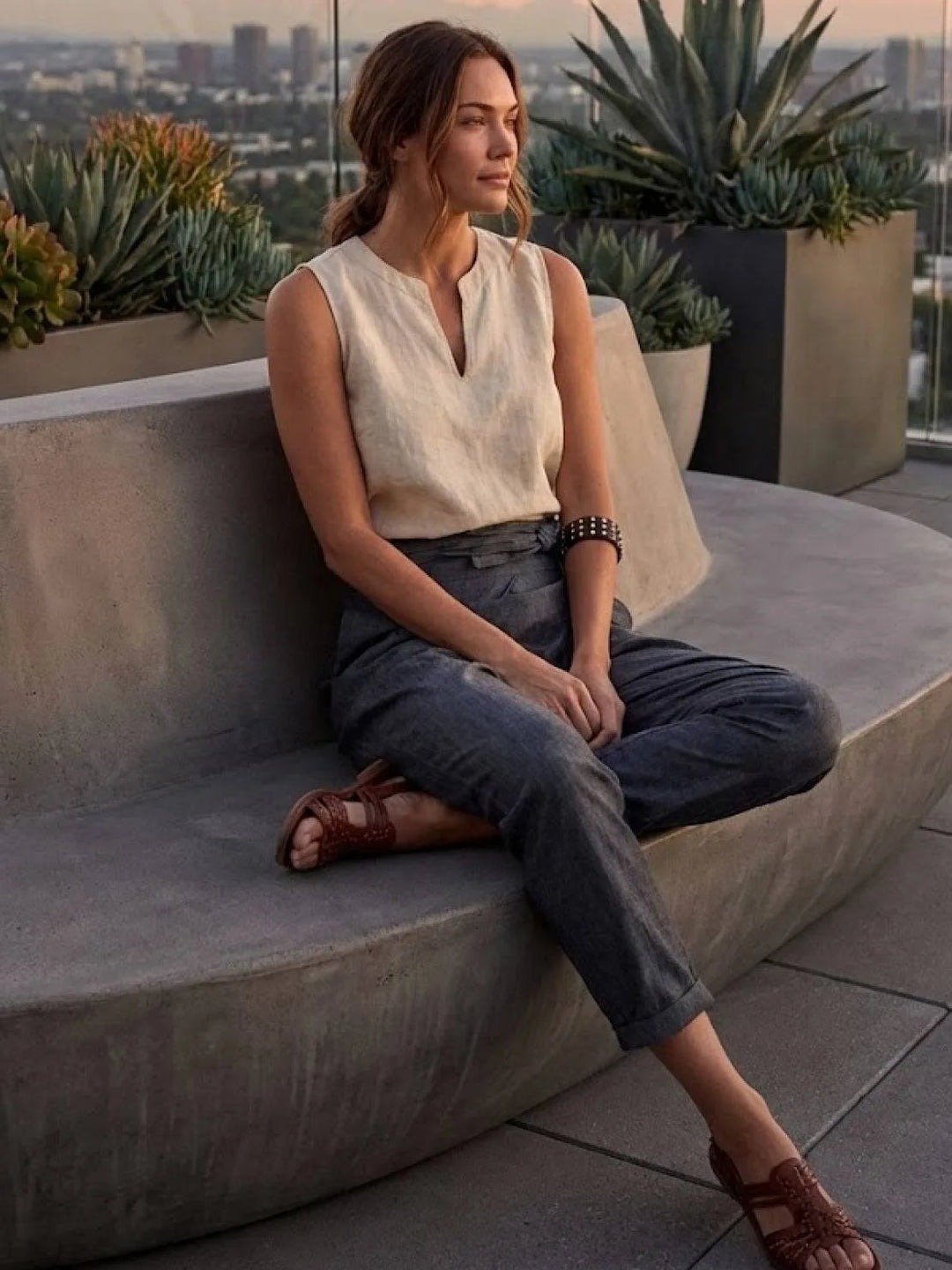 Gray wrap front tapered pants on model, side profile view
