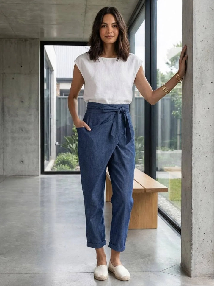 Gray wrap front tapered pants on model, alternate standing view